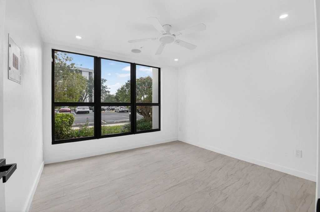Finished Boca West bedroom showing the new window installation and flooring