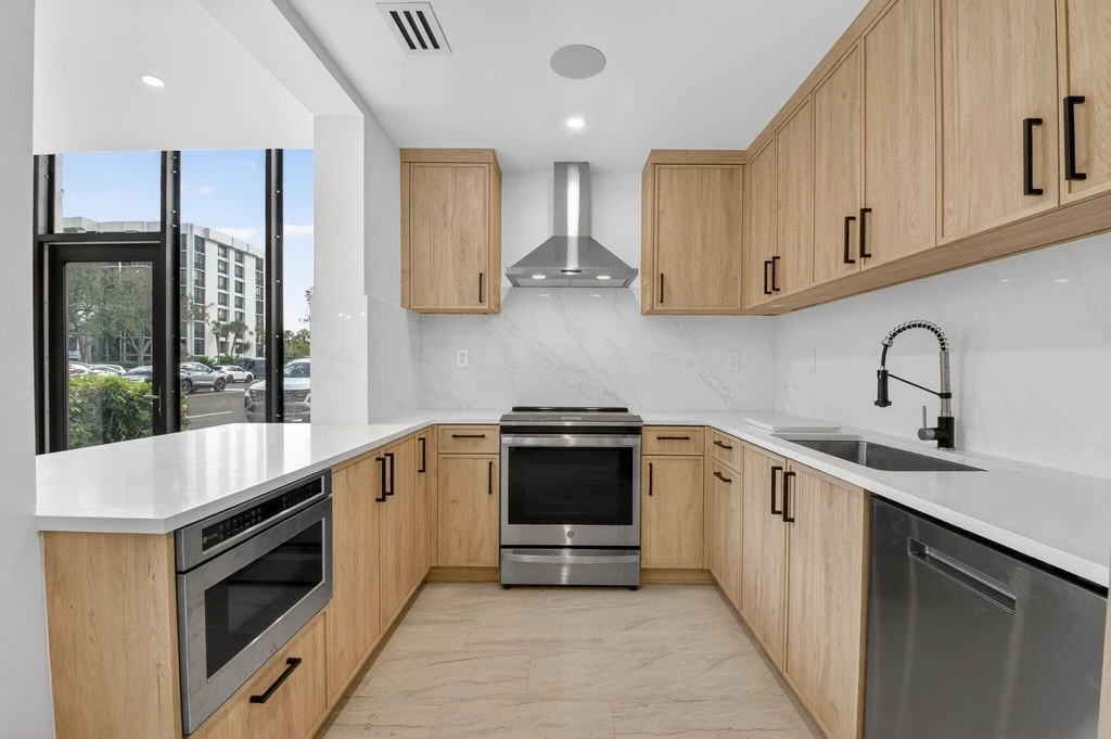 Custom kitchen cabinetry and countertop layout in the completed Boca West gut renovation
