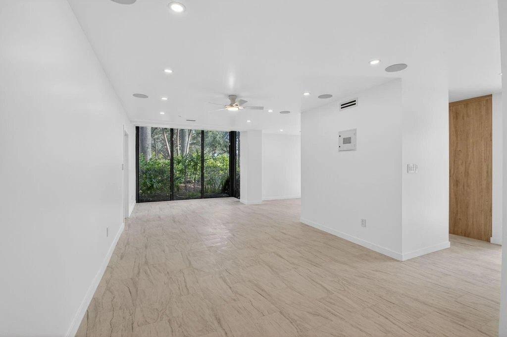 Unstaged renovated Boca West living area showing new flooring and the completed interior
